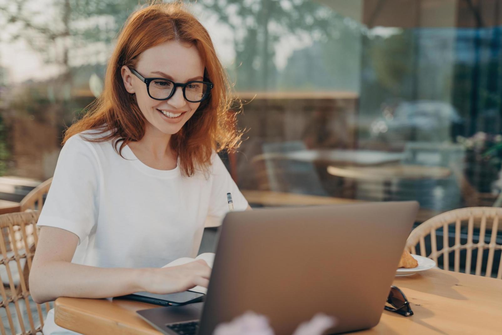 Person reviewing financial documents with coffee